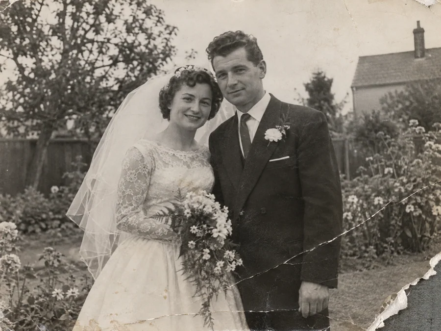 A 1950s wedding portrait with a torn corner — illustrative before photo